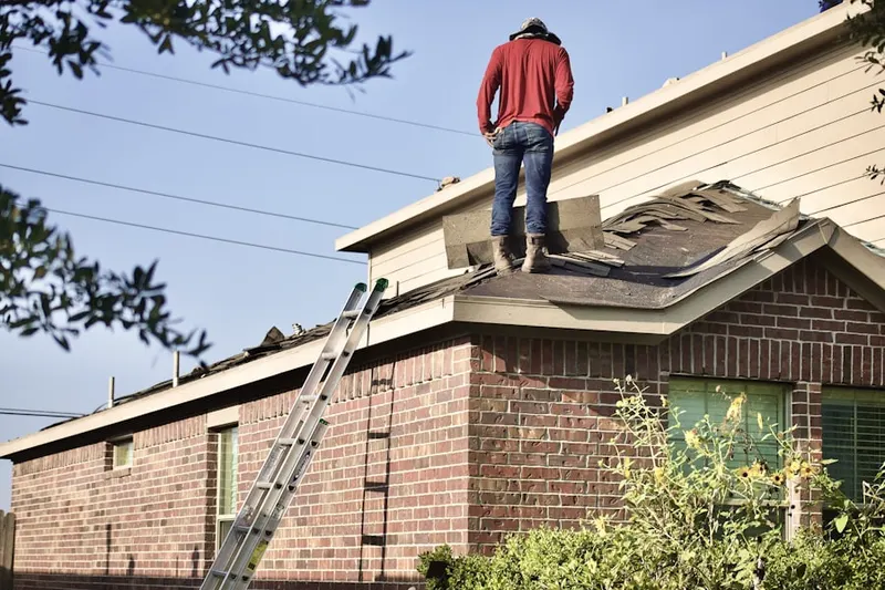 Professional roofer working on a residential roof in Windsor at Peachtree